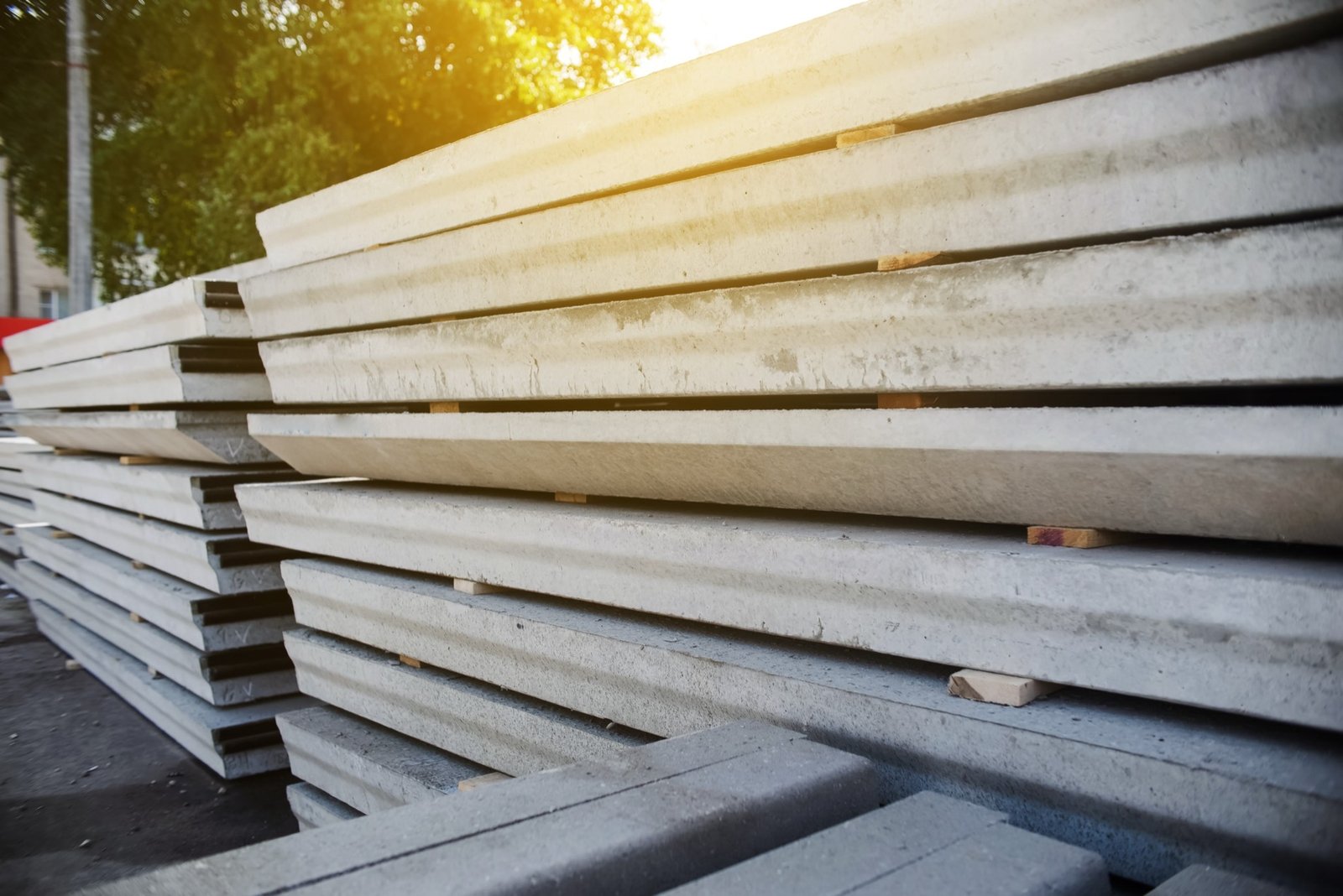 Stacks of precast concrete slabs in warm light